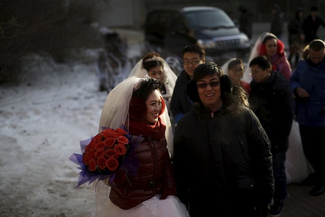 Newly-wed couples attend  their group wedding ceremony which was held as part of the Harbin International Ice and Snow Festival in the northern city of Harbin, Heilongjiang province January 6, 2016. (Photo by Aly Song/Reuters)