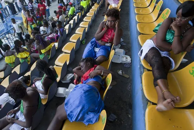 Dancers rest in the stands of the national stadium as they wait for the start of Carnival celebrations in Port-au-Prince,  Haiti, Monday, February 16, 2015. (Photo by Dieu Nalio Chery/AP Photo)