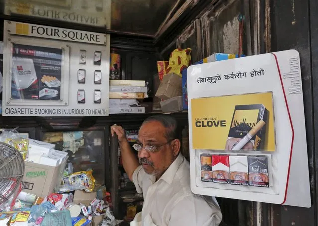 A shopkeeper selling cigarettes waits in his store at a market in Mumbai, India, January 6, 2016. A parliamentary panel in India reviewing whether to put larger health warnings on cigarette packets has asked the health ministry for evidence to show that such a move would cut tobacco consumption, according to documents reviewed by Reuters. (Photo by Shailesh Andrade/Reuters)