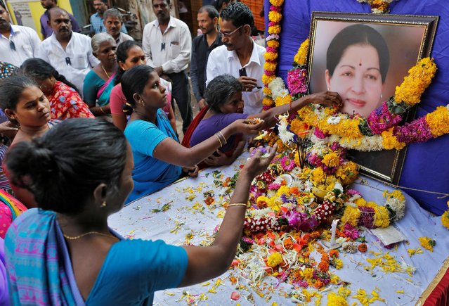 Supporters of Tamil Nadu Chief Minister Jayalalithaa Jayaraman attend a prayer ceremony at the AIADMK party office in Mumbai, India, December 6, 2016. (Photo by Danish Siddiqui/Reuters)