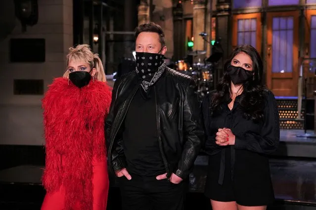 This image released by NBC shows musical guest Miley Cyrus, from left, host Elon Musk, and Cecily Strong during promos in Studio 8H on Thursday, May 6, 2021 in New York. (Photo by Rosalind O'Connor/NBC via AP Photo)