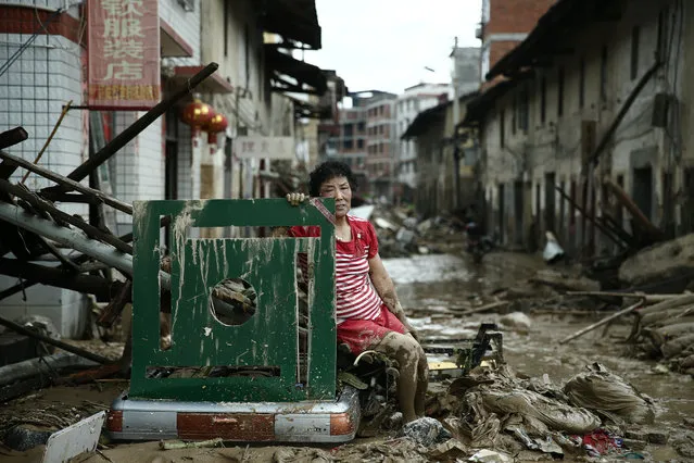 A woman sits on the ruins after typhoon Nepartak swept through Minqing county, Fujian province, China, July 10, 2016. (Photo by Reuters/Stringer)
