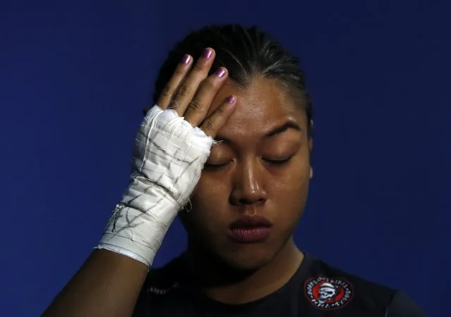 Malaysia's Ann Osman checks her hair before her mixed martial arts (MMA) ONE Championship fight against Egypt's Walaa Abbas in Kuala Lumpur, March 13, 2015. (Photo by Olivia Harris/Reuters)