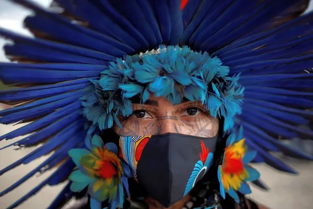 Debora Pataxo, of the Pataxo tribe, looks on during a protest for land demarcation and against President Jair Bolsonaro's government, in front of the Planalto Palace in Brasilia, Brazil on June 14, 2021. (Photo by Adriano Machado/Reuters)
