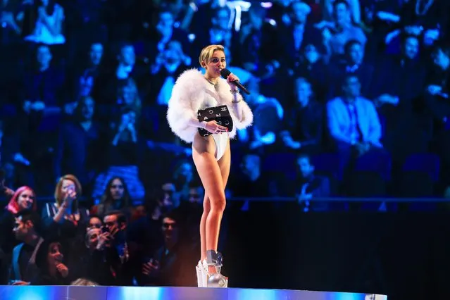 US singer Miley Cyrus smokes as she performs during the MTV Europe Music Awards (EMA) 2013 ceremony in the Ziggo Dome, in Amsterdam on November 10, 2013.   (Photo by Sven Hoogerhuis/AFP Photo)