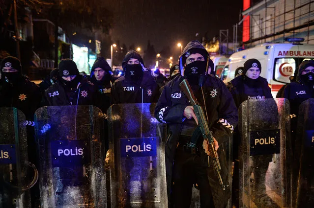 Turkish police officers block the road leading to the scene of an attack in Istanbul, early Sunday, January 1, 2017. (Photo by Depo Photos via AP Photo)