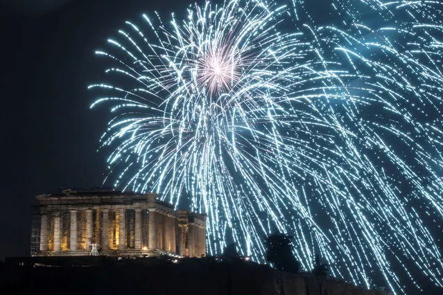 Fireworks explode over the ancient Parthenon temple atop the Acropolis hill during New Year's day celebrations in Athens, Greece, January 1, 2019. (Photo by Alkis Konstantinidis/Reuters)