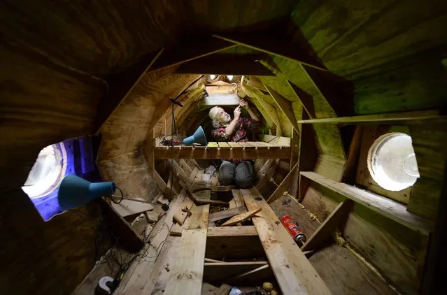 Danny McWilliams, 56, works inside his 36-foot-long replica of Walt Disney movie version of the Nautilus submarine from Jules Verne's “20,000 Leagues Under the Sea” at his rural home in Ellijay, Georgia, USA, 04 December 2013. (Photo by Erik S. Lesser/EPA)