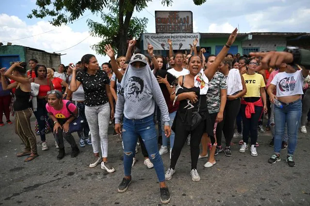 Relatives of inmates wait for news after authorities seized control of the Tocoron prison in Tocoron, Aragua State, Venezuela, on September 20, 2023. Venezuela said Wednesday it had seized control of a prison from the hands of a powerful gang with international reach, in a major operation involving 11,000 members of its security forces. (Photo by Yuri Cortez/AFP Photo)