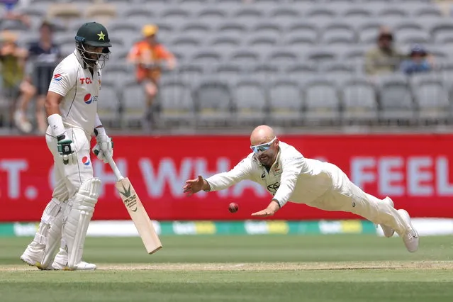 Nathan Lyon of Australia fields off his bowling during Day 3 of the first Test match between Australia and Pakistan at Optus Stadium in Perth, Australia, 16 December 2023.  (Photo by Richard Wainwright/EPA)