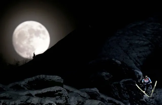 Norway's Anders Bardal jumps during the official training session of the FIS Ski Flying World Cup in Vikersund, Norway on January 25, 2013, while a full moon rises over the mountain. (Photo by Daniel Sannum Lauten/AFP Photo)