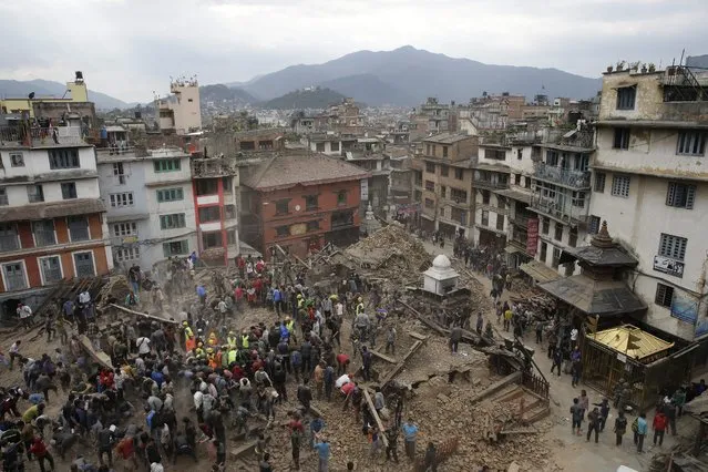 People search for survivors under the rubble of collapsed buuildings in Kathmandu Durbar Square, after an earthquake caused serious damage in Kathmandu, Nepal, 25 April 2015. (Photo by Narendra Shrestha/EPA)