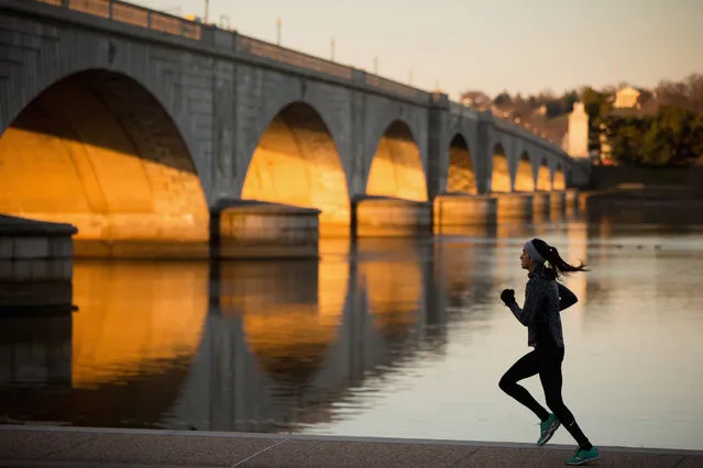A jogger passes by the Arlington Memorial Bridge at sunrise in Washington, Thursday, March 3, 2016. The National Park Service is preparing to patch up the Arlington Memorial Bridge one last time, but even that fix will only extend the life of Washington’s most iconic river crossing by another five years. (Photo by Andrew Harnik/AP Photo)