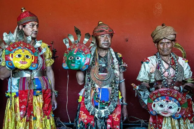 A group of elderly devotees wearing religious attire wait to perform a traditional dance during the Seekaali Festival in Khokana, near Kathmandu, Nepal, 12 October 2021. The centuries old Seekaali festival is celebrated by the Newar community of Khokana as an alternative to Dashain festival, the largest festival for Nepalese Hindus, which celebrates the victory of gods over demons. During the seekaali festival elderly ethnic Newari devotees wear masks of 14 various goddess including Lord Ganesha, Lord Shiva, Lord Laxmi, Lord Brahma and Lord Bishnu. (Photo by Narendra Shrestha/EPA/EFE)