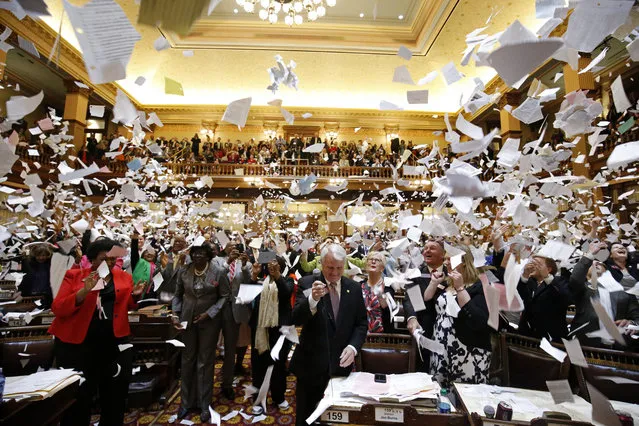 Representatives throw papers up in the air at the conclusion of the final day of the Georgia General Assembly at the capitol in Atlanta, Friday, March 25, 2016. (Photo by Jason Getz/AP Photo)