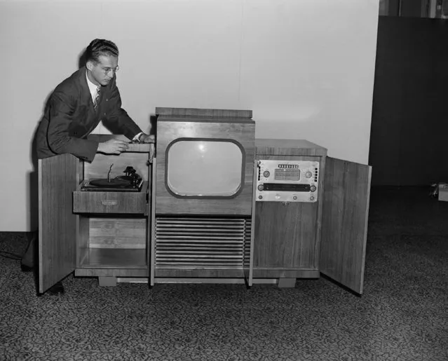 Irwin Cochen is shown looking over the Hampshire Model Du Mont Deluxe television receiver on October 11, 1946 in New York. It has a twenty inch direct view tube which serves as the screen itself. The screen itself is retractable. (Photo by AP Photo)