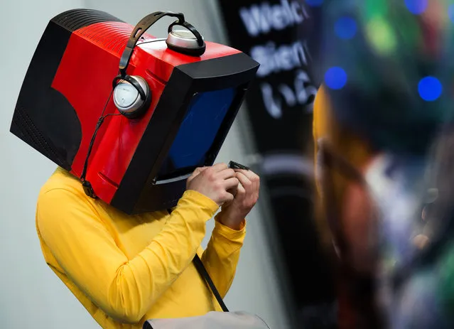 A participant of a cosplay competition wears a monitor model with headphones on his head at the Leipzig Book Fair, in†Leipzig, Germany, March 15, 2014. Around 2,000 publishing houses will present their newest publications at the book fair until 16 March. (Photo by Arno Burgi/EPA)