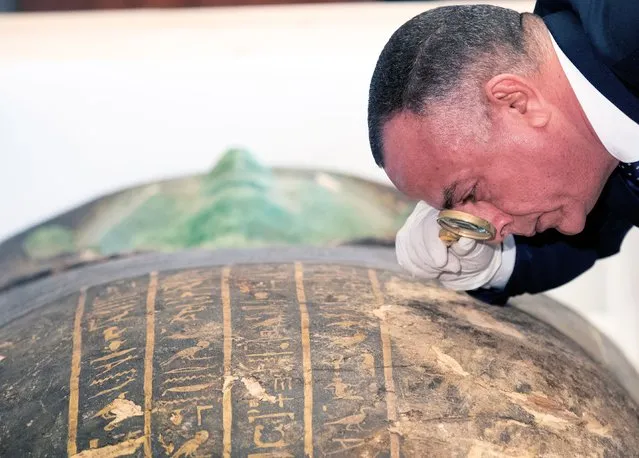 Secretary-General of the Egyptian Supreme Council of Antiquities Mostafa Waziri takes a close look at the ancient Egyptian artefact “Green Sarcophagus” after it was returned from the Houston Museum of Natural Sciences, in Cairo, Egypt, 02 January 2023. Egyptian Foreign Minister Sameh Shoukry and US Charge of Affairs Daniel Rubinstein attended a ceremony on 02 January to celebrate the handing over of the coffin lid known as the “Green Sarcophagus” that was smuggled illegally outside of Egypt and recovered from the Houston Museum of Natural Sciences. The artefact is three meters long carved in wood with columns of hieroglyphic texts dating back to the Late Period (664-332 BC). (Photo by Khaled Elfiqi/EPA/EFE/Rex Features/Shutterstock)