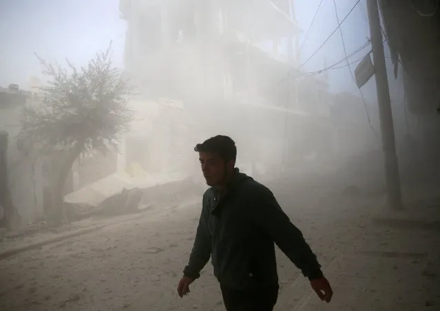A man walks at a site hit by airstrikes in the rebel held besieged Douma neighbourhood of Damascus, Syria February 25, 2017. (Photo by Bassam Khabieh/Reuters)