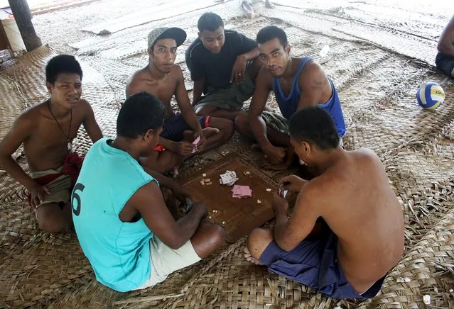 Prisoners play cards under a shelter located in a prison on Kiritimati Island, part of the Pacific Island nation of Kiribati, April 5, 2016. (Photo by Lincoln Feast/Reuters)