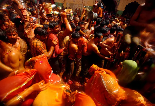 Hindu devotees take part in “Huranga”, a game played between men and women a day after Holi, at Dauji temple near Mathura, March 14, 2017. (Photo by Adnan Abidi/Reuters)