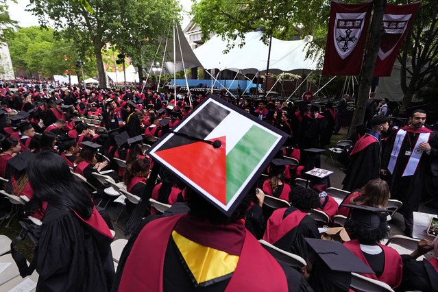 A student displays the Palestinian flag on his mortar board as graduates take their seats in Harvard Yard during commencement at Harvard University, Thursday, May 23, 2024, in Cambridge, Mass. (Photo by Charles Krupa/AP Photo)