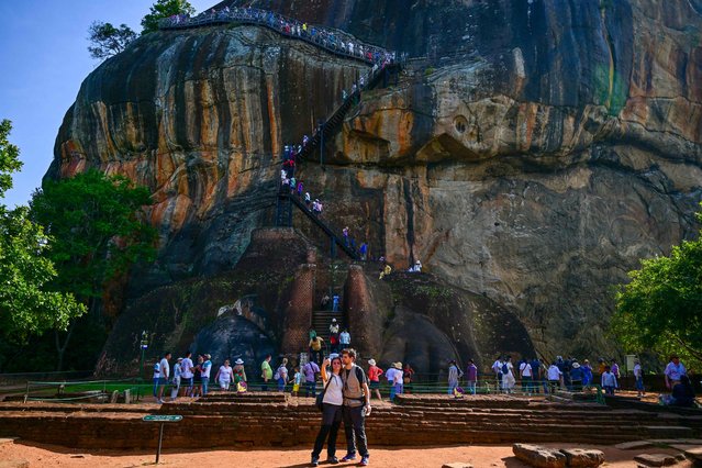 Foreign tourists visit the ancient rock fortress in Sigiriya on February 18, 2024. (Photo by Ishara S. Kodikara/AFP Photo)