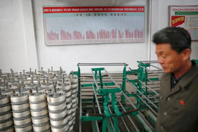 A man passes by an achievement chart placed at the Kim Jong Suk Pyongyang textile mill during a government organised visit for foreign reporters in Pyongyang, North Korea May 9, 2016. (Photo by Damir Sagolj/Reuters)