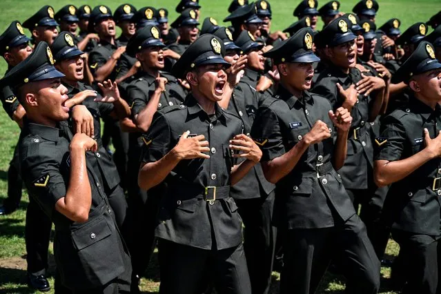 New soldiers in the Indonesian Army celebrate at the end of their graduation ceremony following five months of basic training, in Banda Aceh on February 11, 2022. (Photo by Chaideer Mahyuddin/AFP Photo)