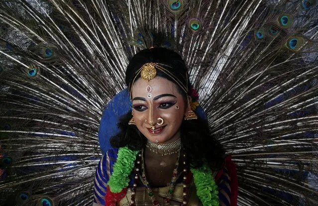 A dancer waits to perform during festivities marking the start of the harvest festival of Onam in Kochi, September 2, 2019. (Photo by Sivaram V/Reuters)