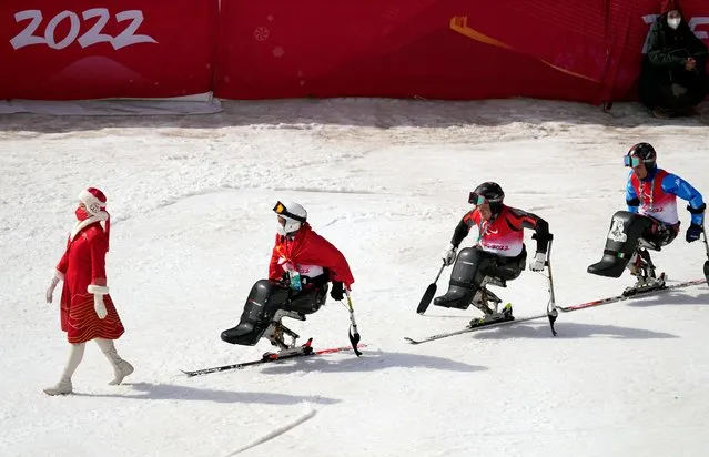 Gold medalist Jesper Pedersen of Norway with silver medalist Rene de Silvestro of Italy and bronze medalist Liang Zilu of China are seen during the flower ceremony for the Para Alpine Skiing, Men's Giant Slalom Sitting on March 10, 2022. (Photo by Aly Song/Reuters)
