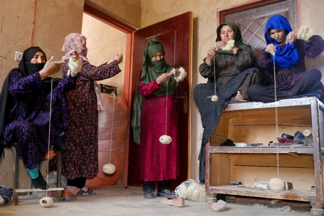 Afghan women spin wool into yarns at a factory in Herat on May 29, 2024. (Photo by Mohsen Karimi/AFP Photo)