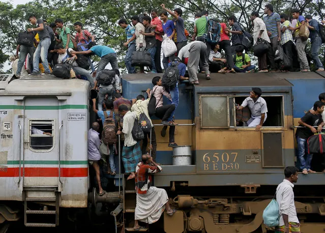 Bangladeshi Muslims try to climb on to the roof of an overcrowded train as they head to their homes ahead of Eid al-Fitr at a railway station in Dhaka, Bangladesh, Thursday, July 16, 2015. Hundreds of thousands of people working in Dhaka plan to leave for their home towns to celebrate with their family the upcoming Eid al-Fitr. (Photo by A. M. Ahad/AP Photo)