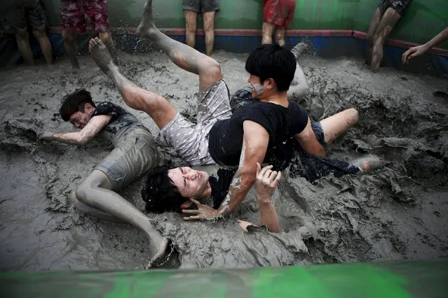 Tourists play in a mud pool the Boryeong during Mud Festival at Daecheon beach in Boryeong, South Korea, July 18, 2015. (Photo by Kim Hong-Ji/Reuters)