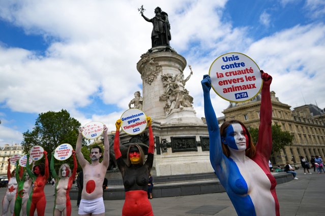 Activists painted in the colours of the world's flags take part in a demonstration, called by the NGO the Ethical Treatment of Animals (PETA), to protest against the use of animals in fashion, at Place de la Republique in Paris, on July 22, 2024. (Photo by Bertrand Guay/AFP Photo)