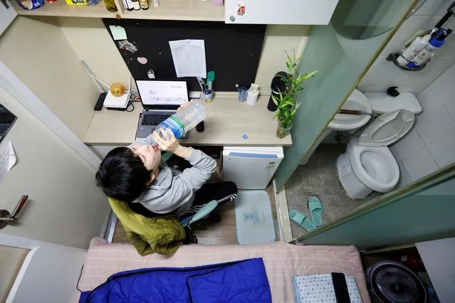 Kim Jae-hoon drinks water as he sits in his cubicle, called a goshi-won, where he lives in Suwon, South Korea, November 7, 2019. (Photo by Kim Hong-Ji/Reuters)