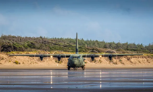 The C-130J transporter battled heavy showers and a strong cross wind to make the unusual touchdown at Cefn Sidan Sands, near Pembrey, England on August 6, 2019. Former RAF engineer Ally McMurdo took photos of the aircraft, which was flown by 24 Squadron, based at RAF Brize Norton in Oxfordshire. (Photo by Ally McMurdo/Bav Media)