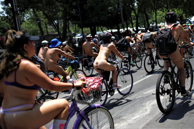 Cyclists perform their annual nude bike ride to protest car-centric culture and demand cyclist rights in Mexico City, Mexico on June 10, 2023. (Photo by Raquel Cunha/Reuters)