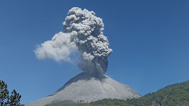 Mount Lewotobi Laki-laki spews volcanic ash during an eruption as seen from Boru village in East Flores, East Nusa Tenggara, on July 14, 2024. (Photo by Arnold Welianto/AFP Photo)