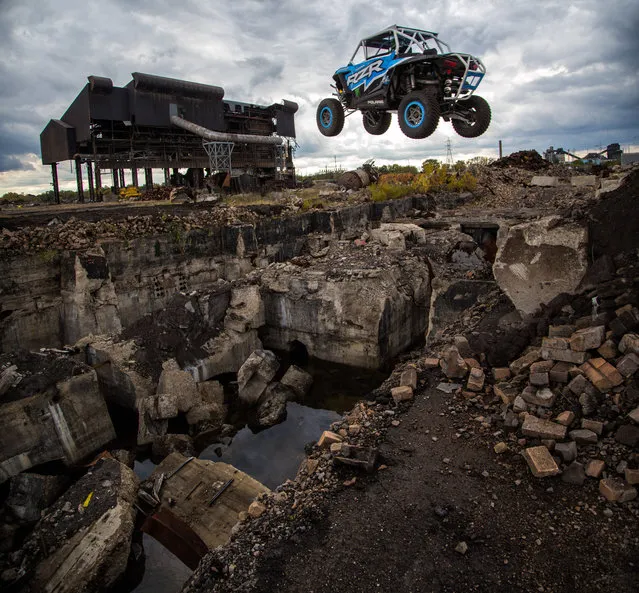 Leap of faith: RJ takes on another incredible jump on October, 2015 in Ohio, USA.  A turbocharged off-road vehicle performs a death-defying leap through the second storey of a derelict building. Filmed in October by filmmaker siblings, Matt Martelli, 43, and Joshua Martelli, 41, the thrilling footage shows champion Californian racer RJ Anderson, 20, pushing a utility task vehicle (UTV) to the limit. (Photo by Mad Media/Barcroft Cars)