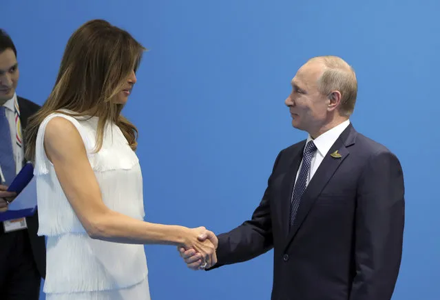 Russian President Vladimir Putin shakes hands with U.S. First Lady Melania Trump during a meeting on the sidelines of the G20 summit in Hamburg, Germany July 7, 2017. (Photo by Mikhail Klimentyev/Reuters/Sputnik/Kremlin)