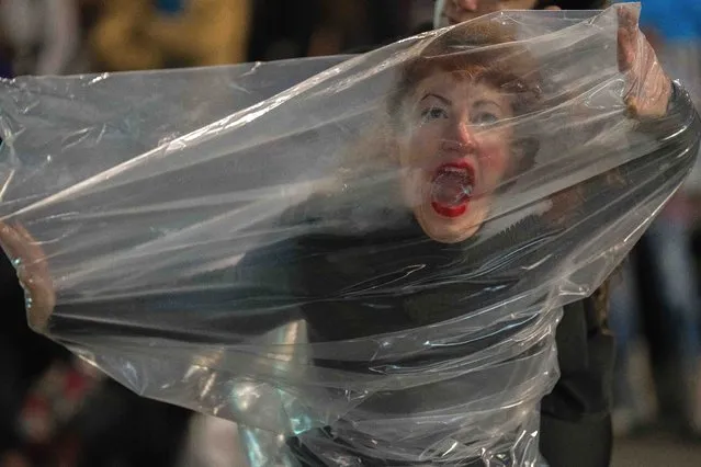 A woman performs during a demonstration marking the 7th anniversary of the Ni Una Menos, or Not One Less, women's movement,  in downtown Montevideo, Uruguay, Friday, June 3, 2022. A grassroots movement that began in Argentina that mobilized to fight violence against women, Ni Una Menos, spread rapidly worldwide with branches in New York, Berlin, Italy, Brazil, Costa Rica, Ecuador and more. (Photo by Matilde Campodonico/AP Photo)