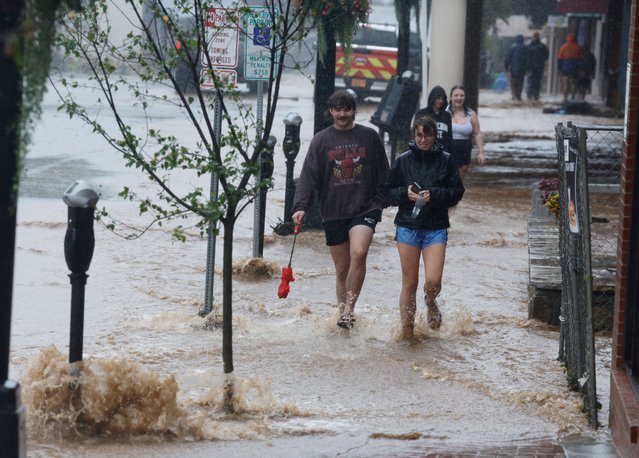 University students walk through flowing flood waters in the town’s main King Street thoroughfare as Tropical Storm Helene strikes, in Boone, North Carolina on September 27, 2024. (Photo by Jonathan Drake/Reuters)