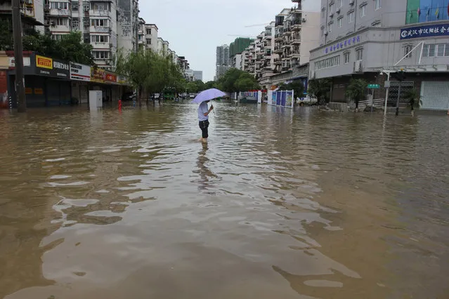 A man walks on a flooded street in Wuhan, Hubei Province, China, June 19, 2016. (Photo by Reuters/Stringer)
