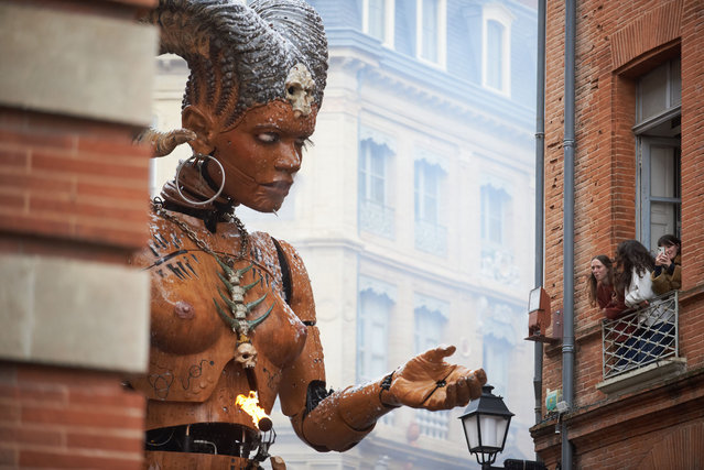 Lilith interacts with spectators in the streets of Toulouse. French street show creator Francois Delaroziere, director of the art company “La Machine”, creates a show in the streets of Toulouse. The new show displays giant characters: Asterion, the Minotaur; Lilith, the scorpion woman; and Ariane, the spider woman. Lilith is fond of the Minotaur and wants to take Asterion to hell with her. Ariane protects Asterion and tries everything to keep Asterion safe. The show is displayed over three days and is attended by dozens of people. During the three days, the giant characters appear in the streets of Toulouse. (Photo by Alain Pitton/NurPhoto)