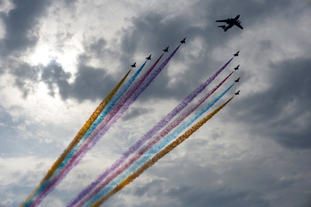Aircraft perform during a rehearsal for a military parade in Beijing, August 23, 2015. Troops from at least 10 countries including Russia and Kazakhstan will join an unprecedented military parade in Beijing next month to commemorate China's victory over Japan during World War Two, Chinese officials said. (Photo by Reuters/Stringer)