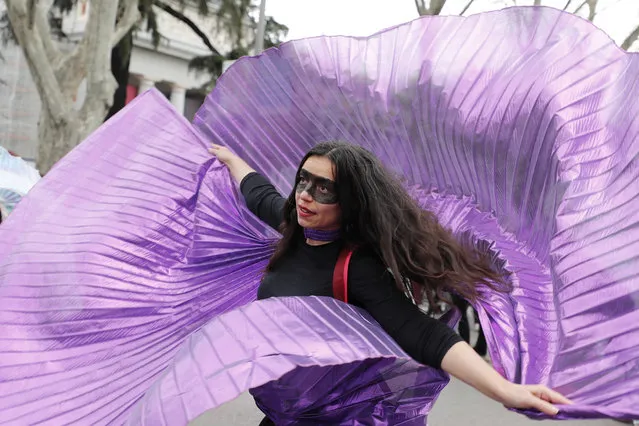 A protester dances during a march on International Women's Day in Madrid, Spain, Sunday, March 8, 2020, Thousands of women are marching in Madrid and other Spanish cities as part of International Women's Day. (Photo by Paul White/AP Photo)