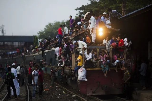Bangladeshi Muslims travel on an overcrowded train as they head to their hometowns ahead of Eid al-Adha in Dhaka, Bangladesh, Friday, September 1, 2017. (Photo by Bernat Armangue/AP Photo)