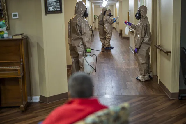 Members of an Infection Control Team from the Georgia Army National Guard's 138th Chemical Company disinfect the Wellstar Atherton Place senior care facility from possible contamination of the coronavirus COVID-19 virus in Marietta, Georgia, USA, 20 April 2020. Several of the teams have dispatched to nursing homes and other long-term care facilities throughout the state during the coronavirus COVID-19 pandemic. (Photo by Erik S. Lesser/EPA/EFE/Rex Features/Shutterstock)