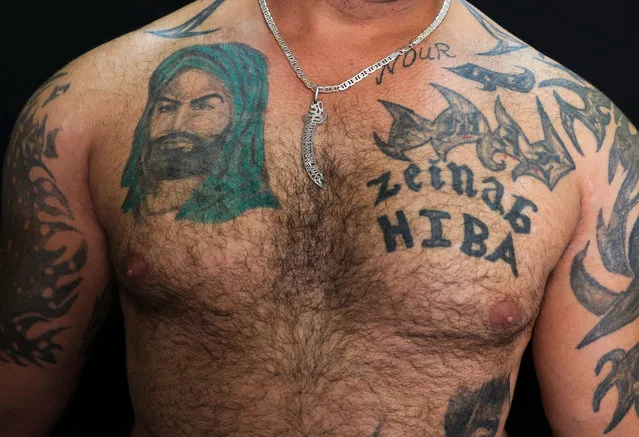 In this Tuesday, July 19, 2016 photo, Zulfiqar, 30, poses for a photo showing his tattoo of Shiite Muslims' first Imam Ali, left, in the southern suburb of Beirut, Lebanon. (Photo by Hassan Ammar/AP Photo)